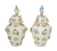 A Pair of Meissen Porcelain Covered Jars with Figural Finials