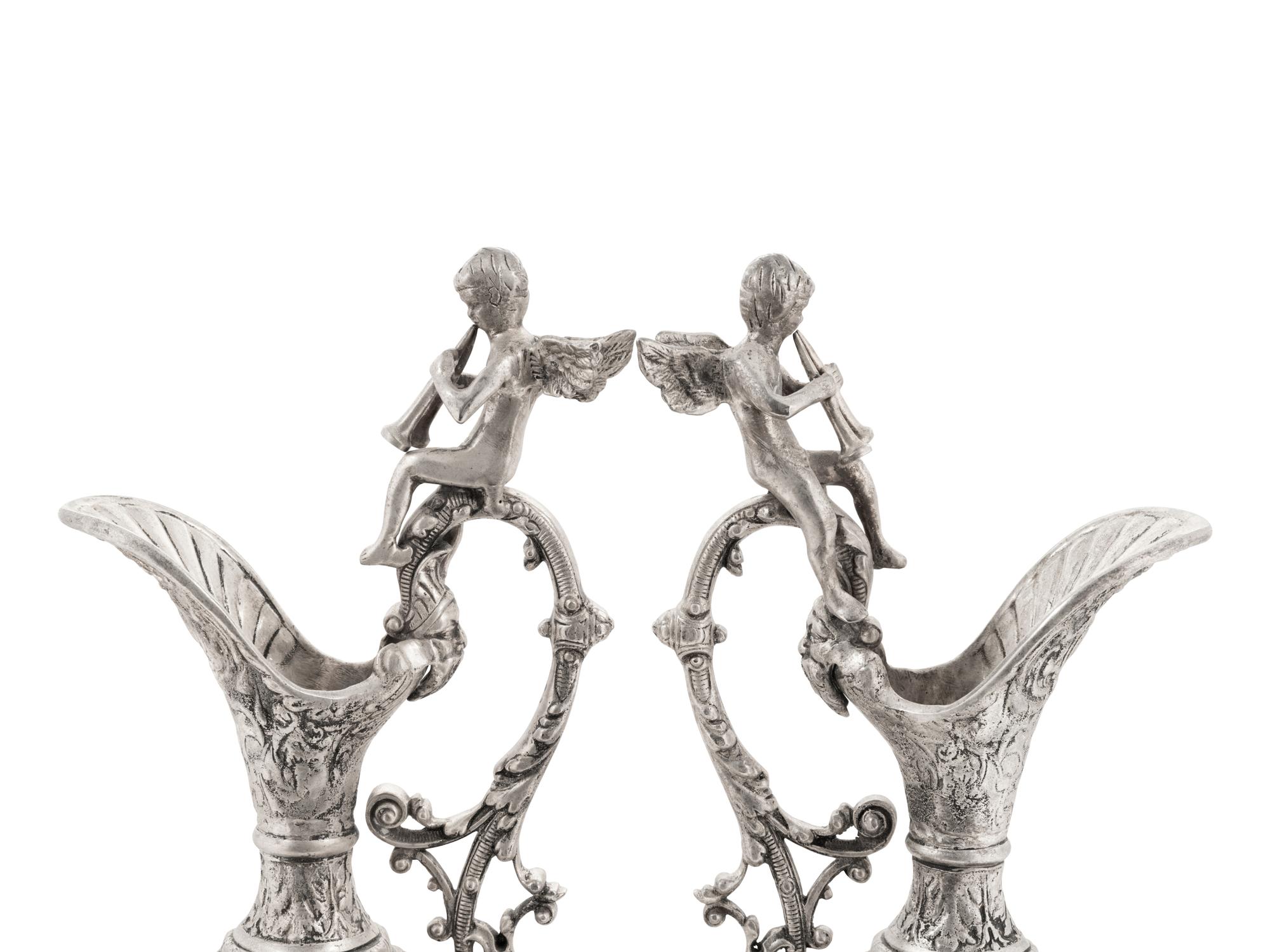 A Pair of Neoclassical Style White Metal Ewers