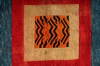A Tibetan Silk Patchwork Offering Cloth and A Tibetan Rug