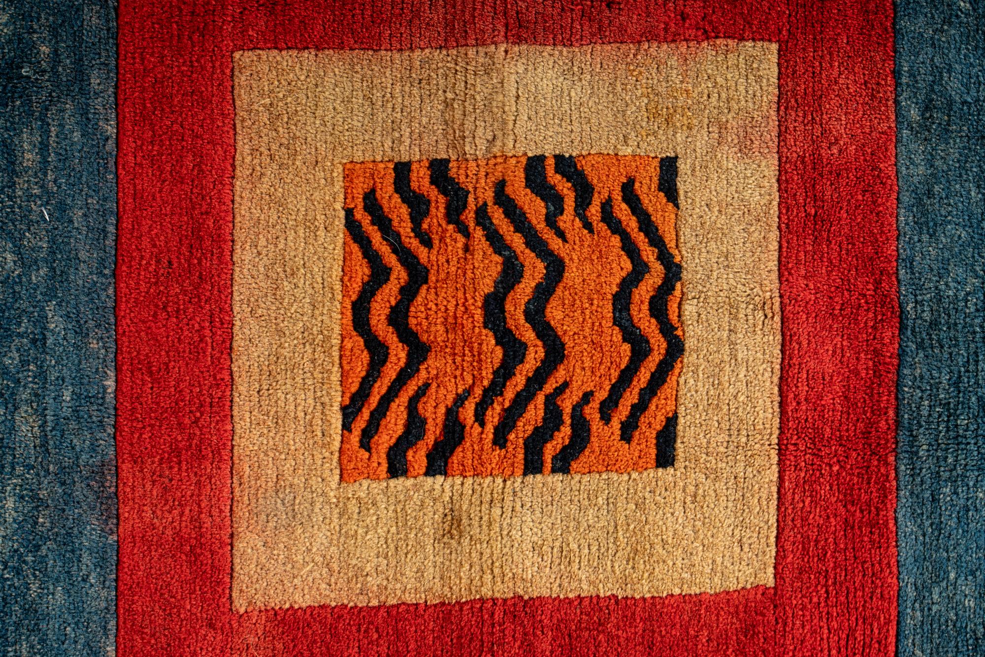 A Tibetan Silk Patchwork Offering Cloth and A Tibetan Rug