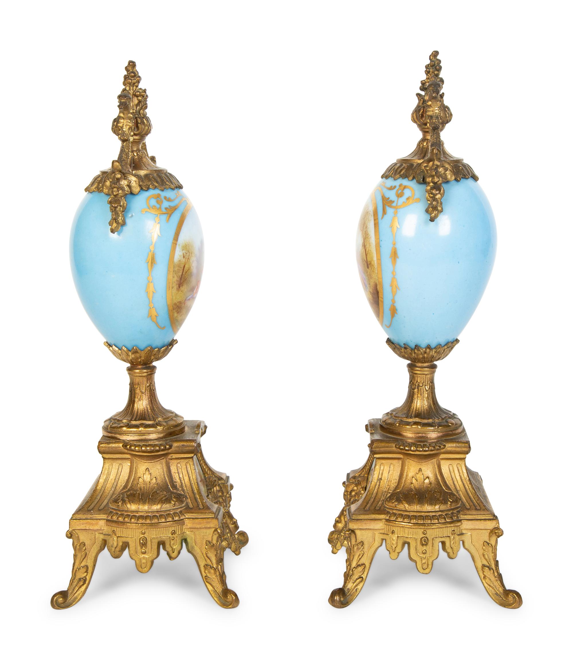 A Pair of Sèvres Style Porcelain Small Urns with Gilt Metal Mounts