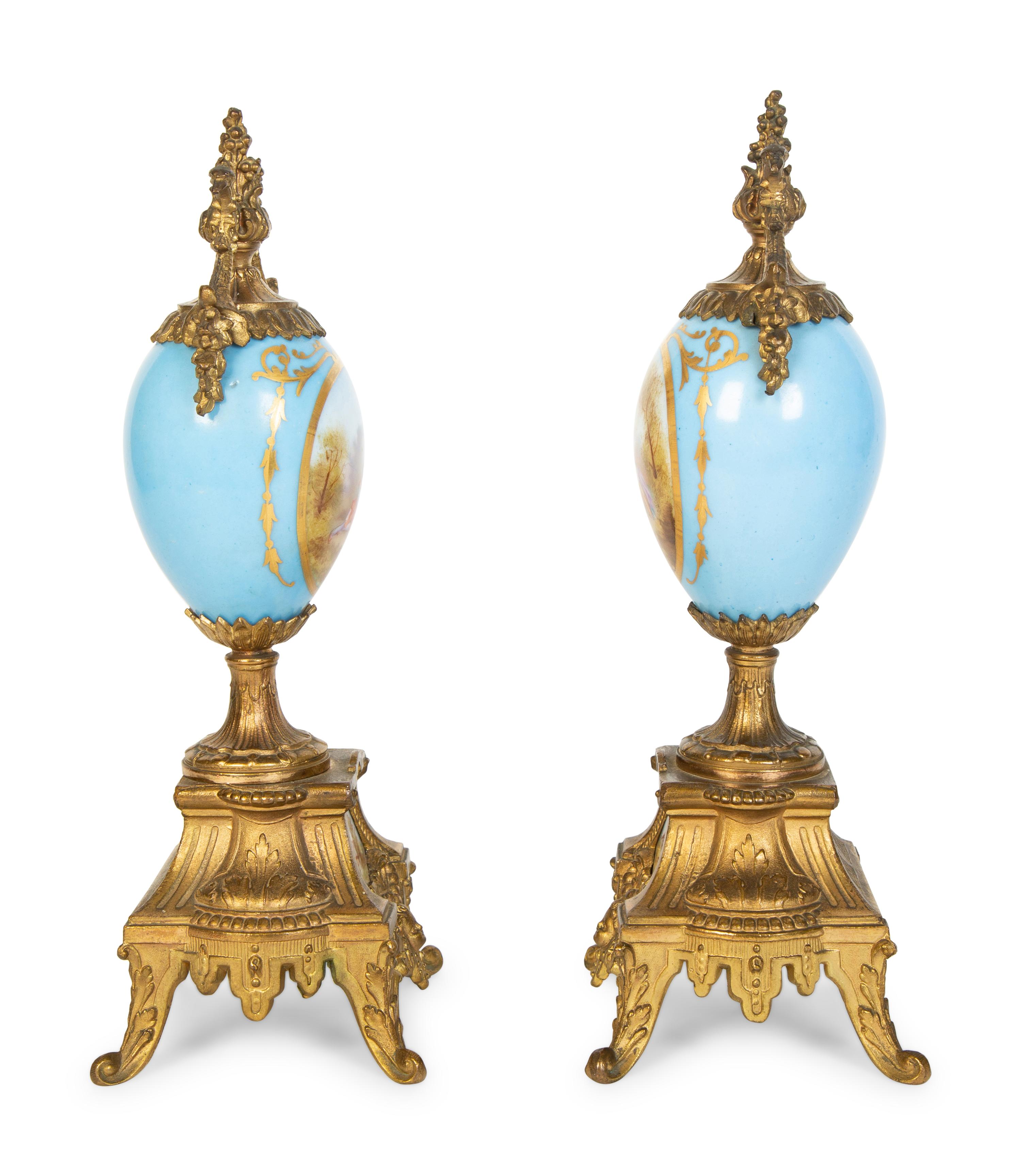 A Pair of Sèvres Style Porcelain Small Urns with Gilt Metal Mounts
