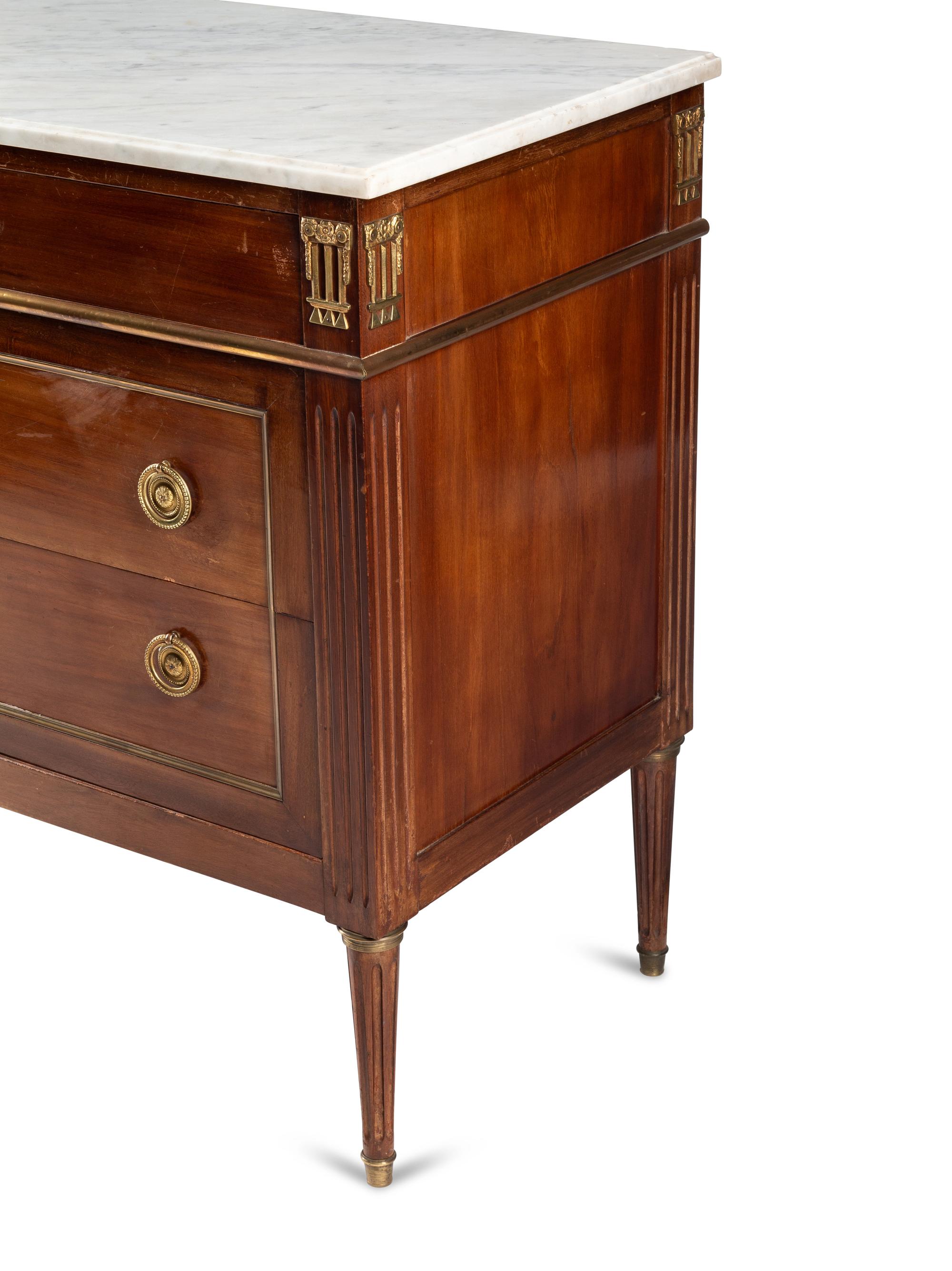 A Louis XVI Style Gilt Bronze Mounted Mahogany Marble-Top Commode