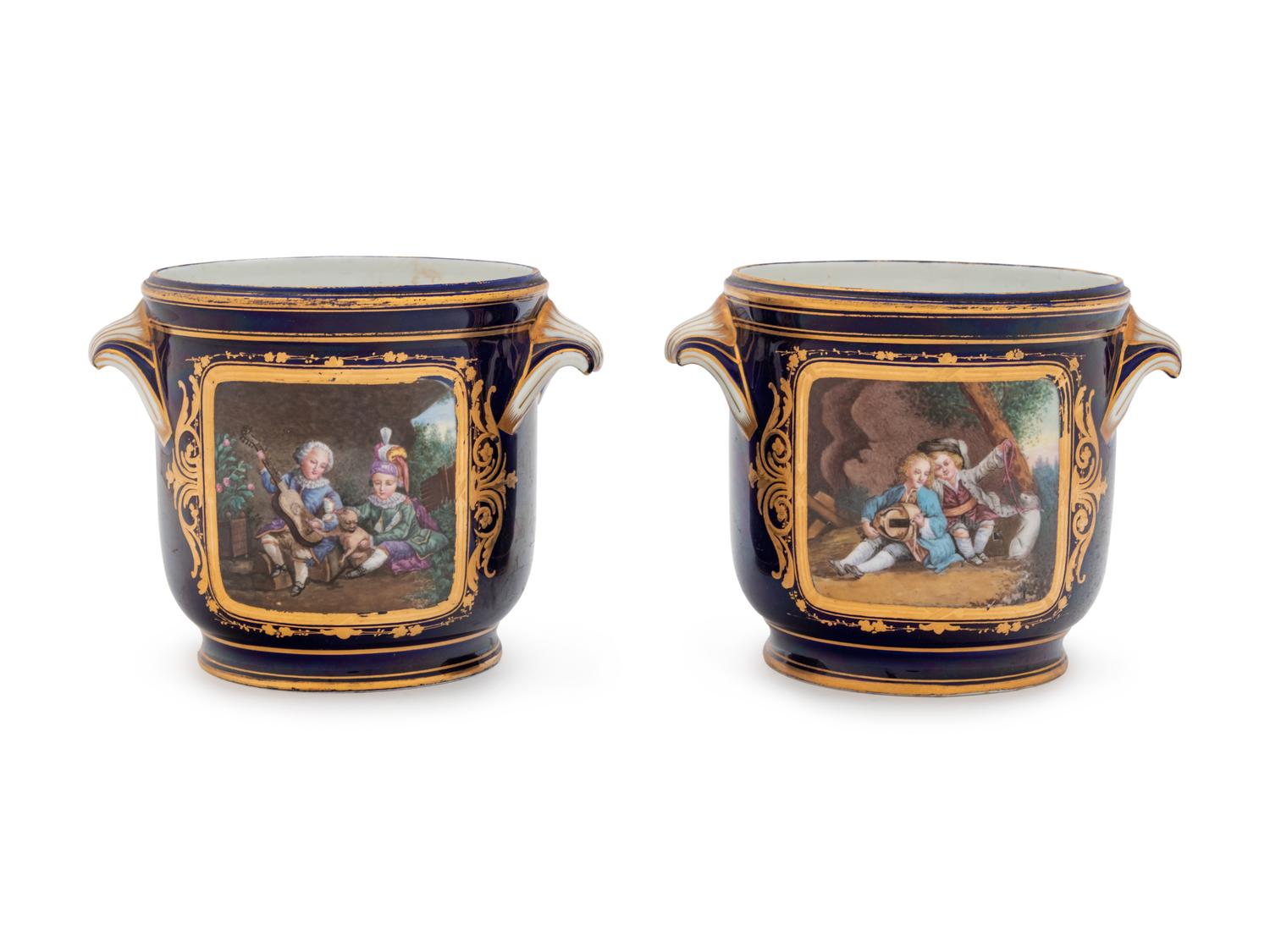 A Pair of Sèvres Style Painted and Parcel Gilt Porcelain Cache Pots