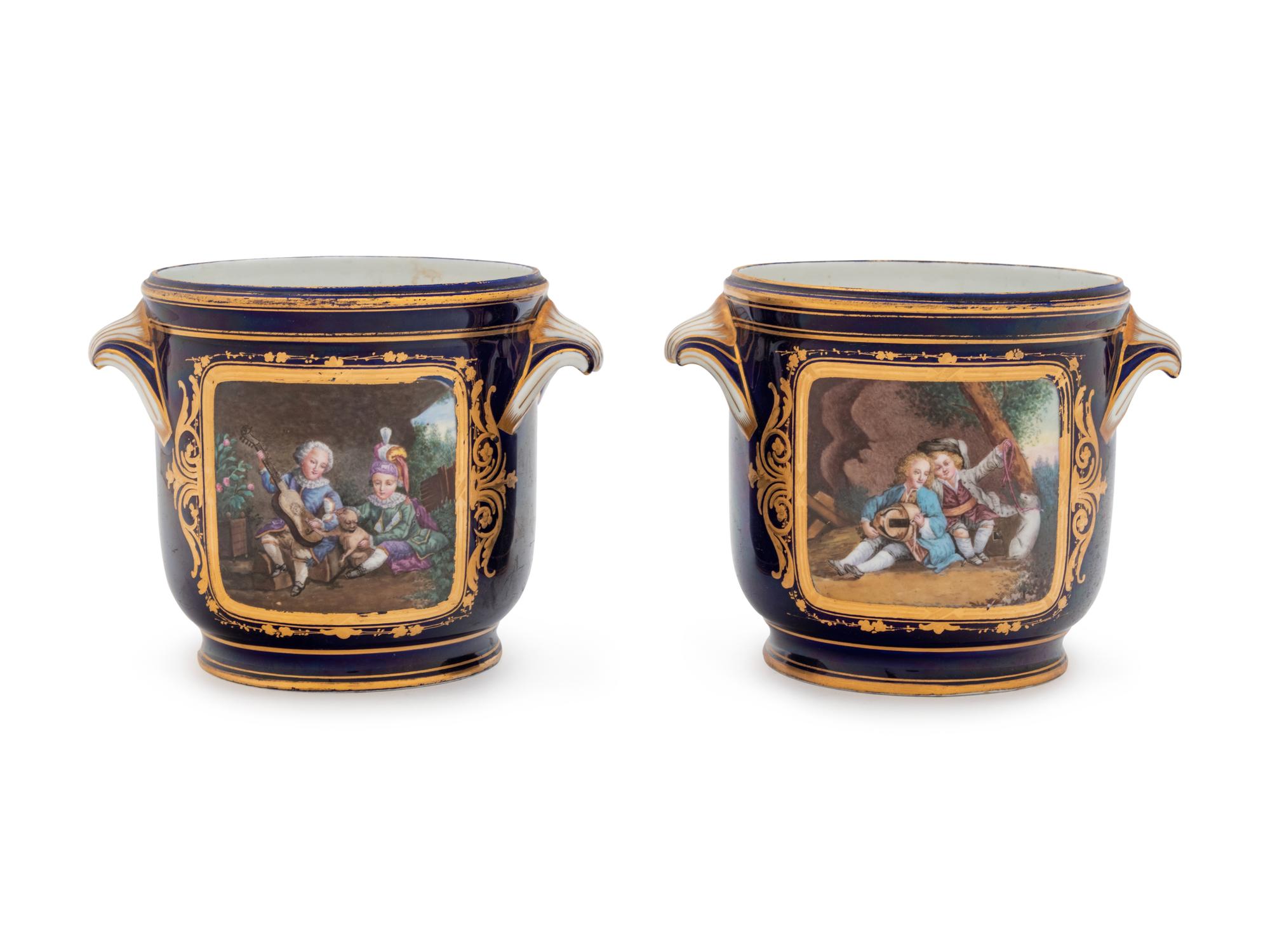 A Pair of Sèvres Style Painted and Parcel Gilt Porcelain Cache Pots