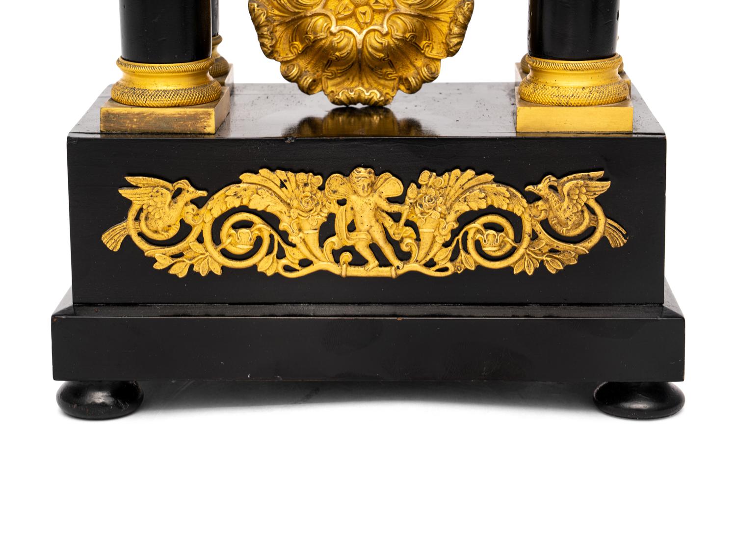 A Charles X Gilt Bronze Mounted Ebonized Fruitwood Clock