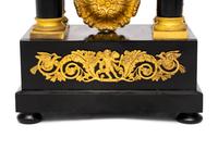 A Charles X Gilt Bronze Mounted Ebonized Fruitwood Clock