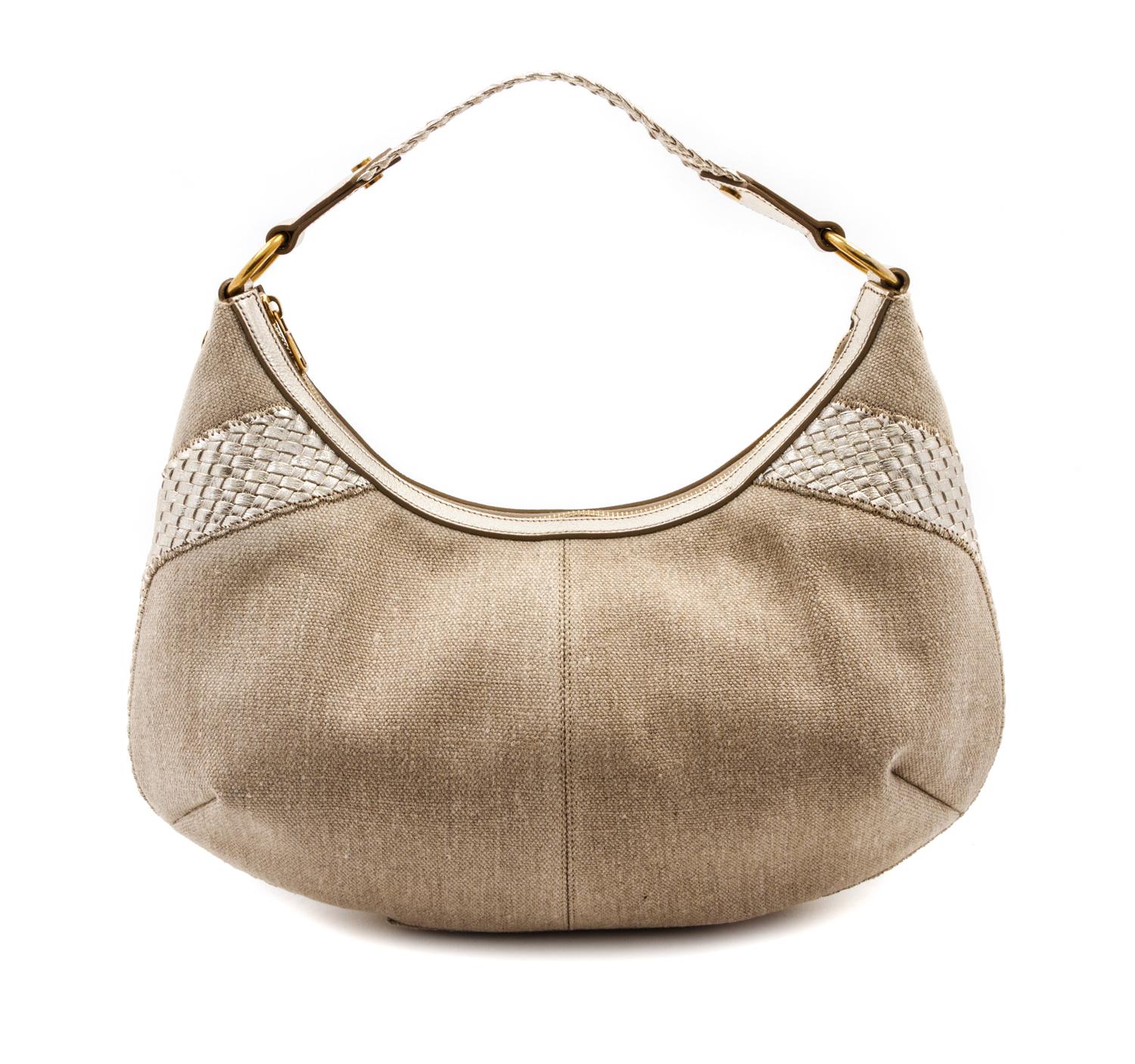 An Yves Saint Laurent Tan Canvas and Metallic Leather Bag, 15 x 11 x 2 inches.
