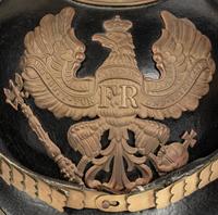 A Collection of Twenty-One Military Parade Helmets, Hats and Masks