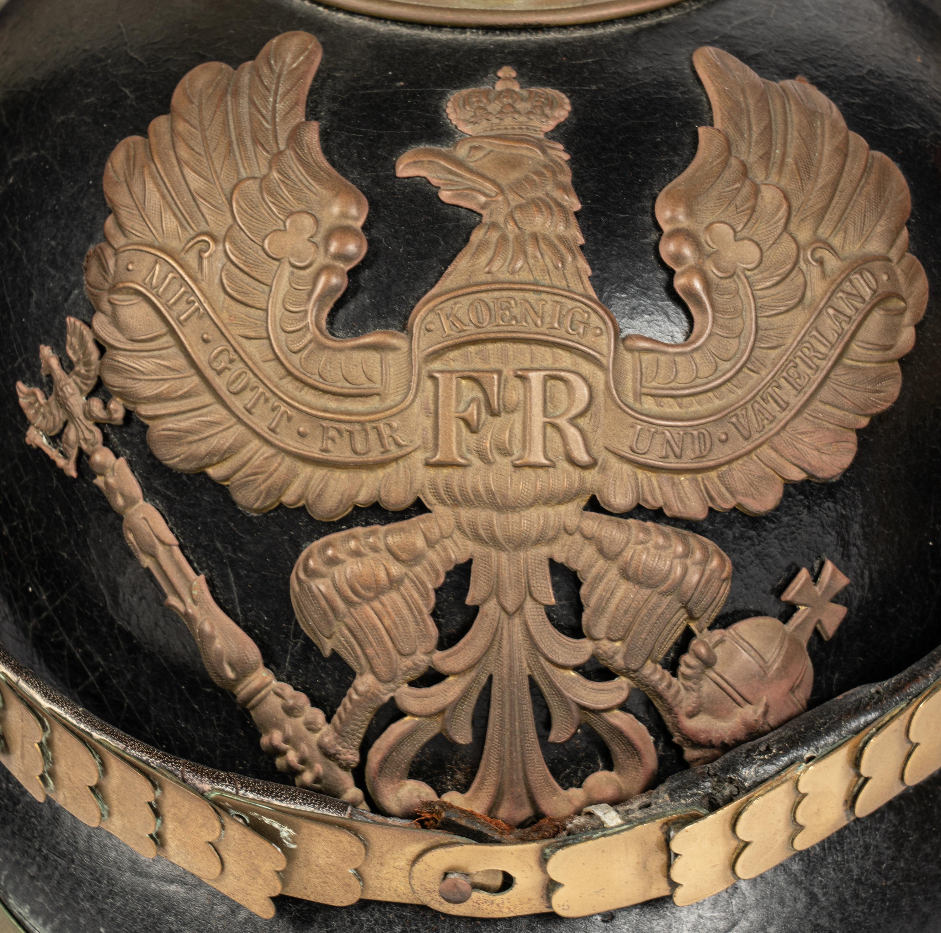 A Collection of Twenty-One Military Parade Helmets, Hats and Masks