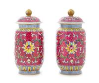 A Pair of Ruby Pink Ground Famille Rose Porcelain Covered Jars Height of each 6 1/4 inches. — 20TH CENTURY