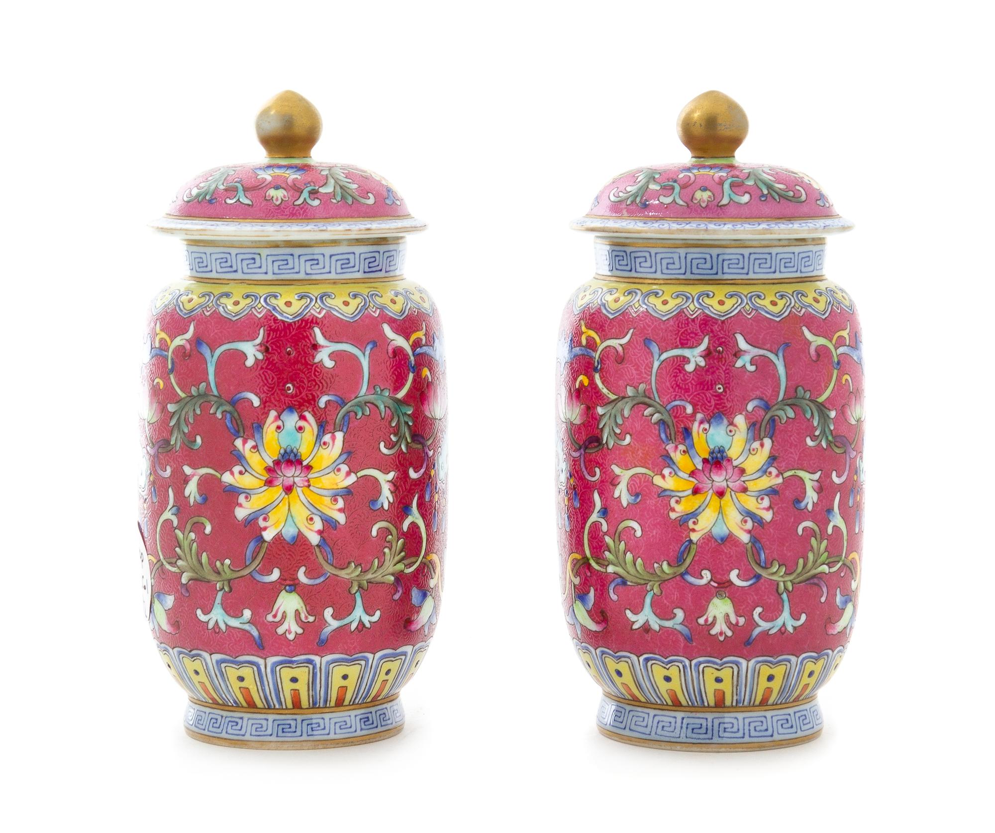 A Pair of Ruby Pink Ground Famille Rose Porcelain Covered Jars Height of each 6 1/4 inches. — 20TH CENTURY