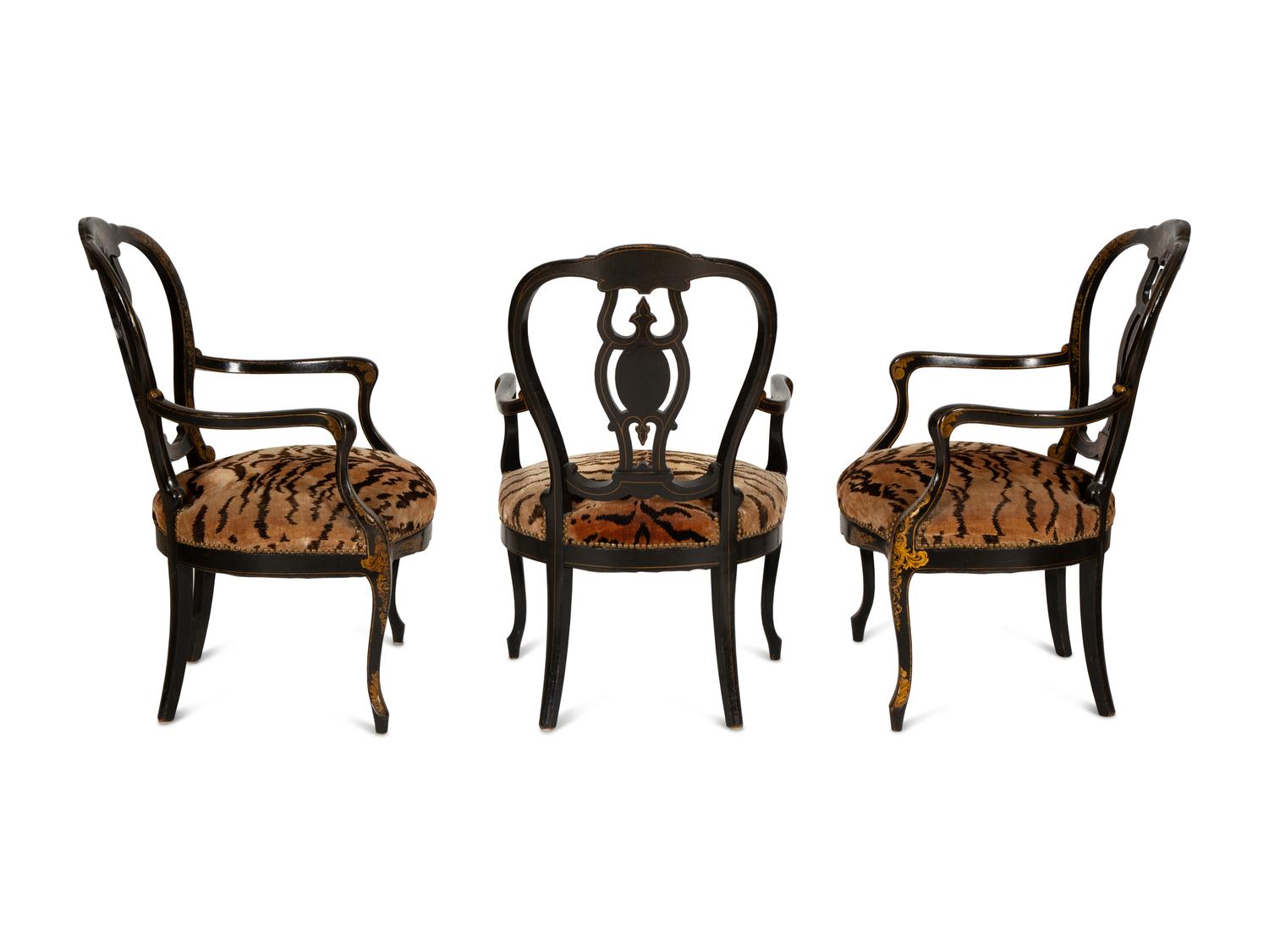 A Set of Three Victorian Ebonized Gilt and Mother of Pearl Chinoiserie Open Armchairs