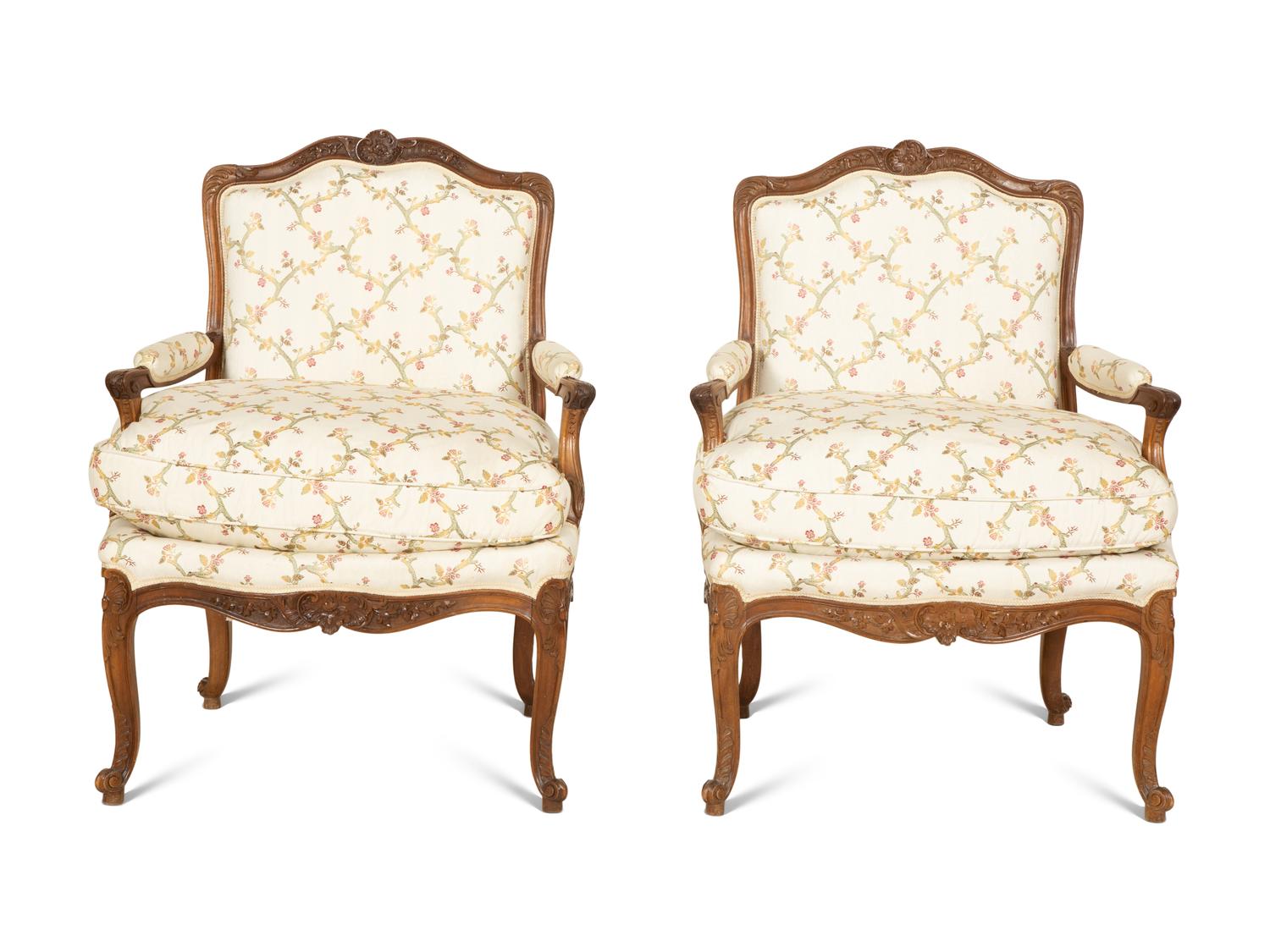 A Pair of Louis XV Style Carved Mahogany Fauteuils