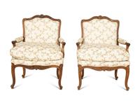 A Pair of Louis XV Style Carved Mahogany Fauteuils