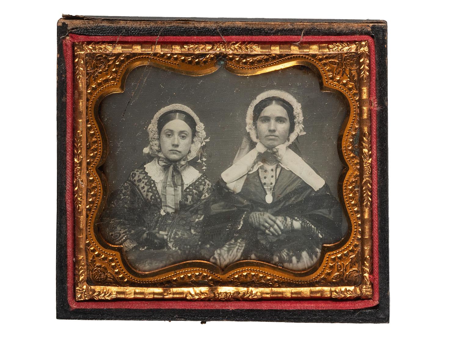 [EARLY PHOTOGRAPHY]. A group of 3 daguerreotypes featuring family groups, highlighted by a portrait of 11 family members, comprising: