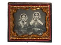 [EARLY PHOTOGRAPHY]. A group of 3 daguerreotypes featuring family groups, highlighted by a portrait of 11 family members, comprising: