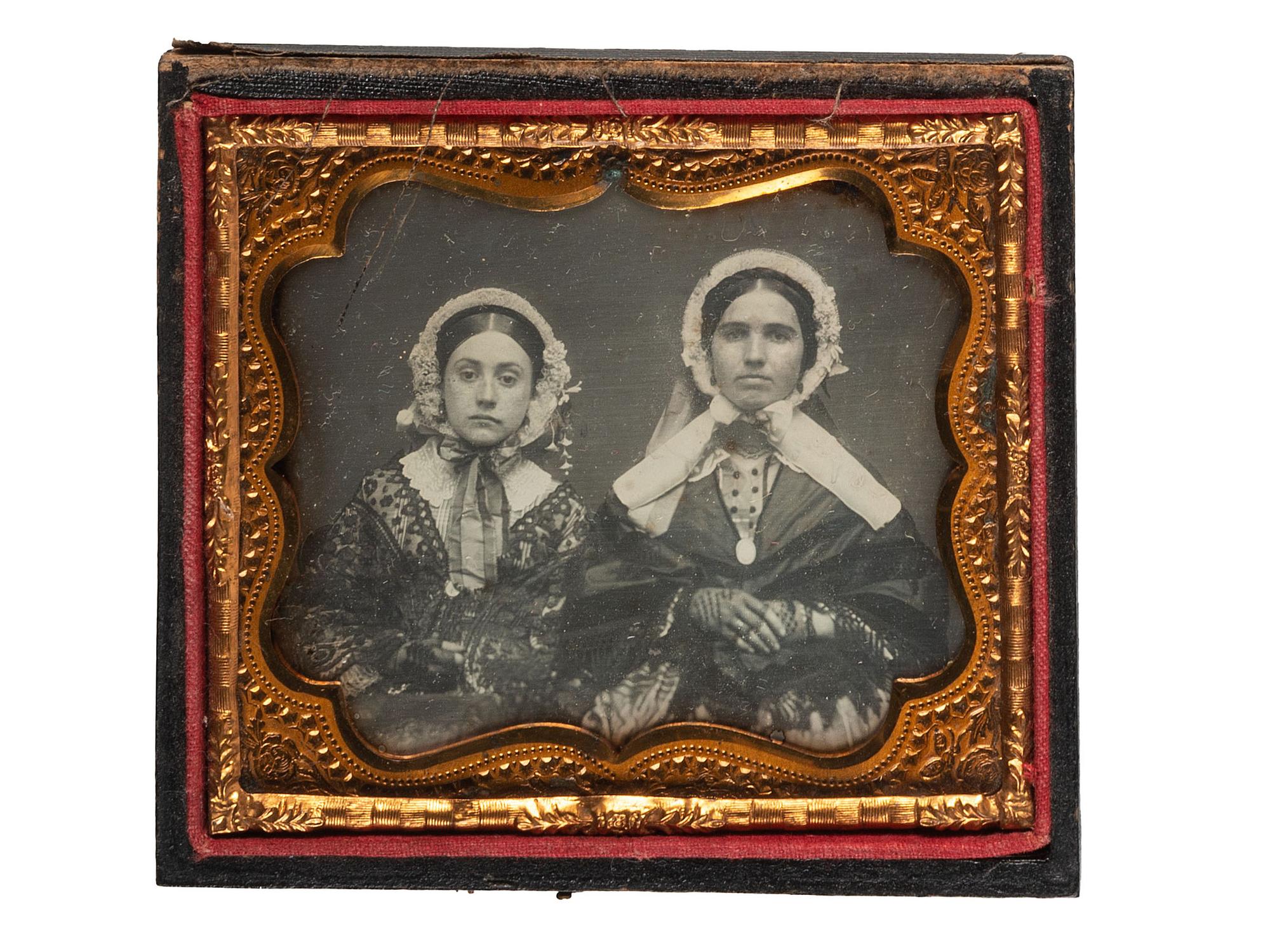 [EARLY PHOTOGRAPHY]. A group of 3 daguerreotypes featuring family groups, highlighted by a portrait of 11 family members, comprising: