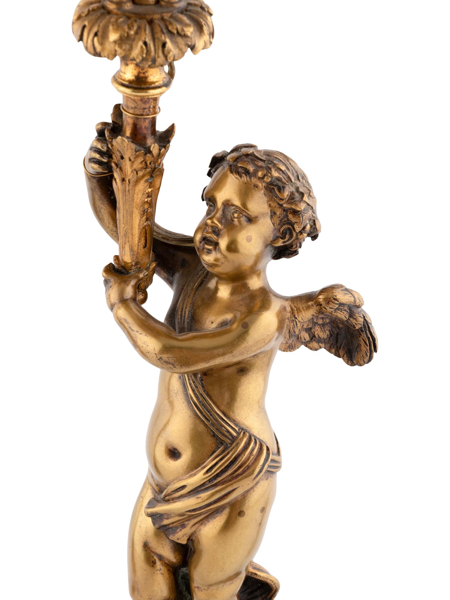 A Pair of French Gilt Bronze and Marble Three-Light Figural Candelabra