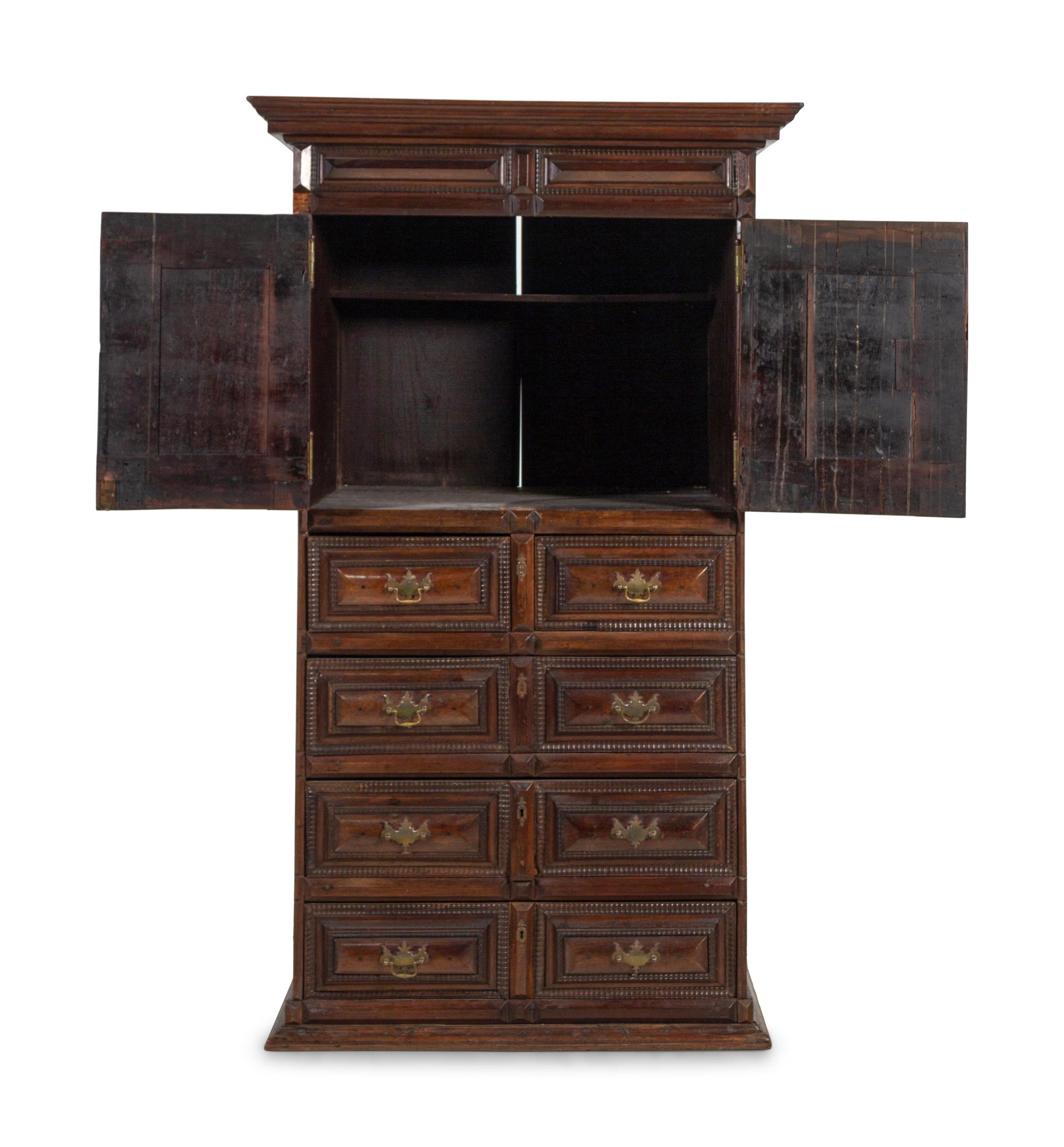 A Dutch Carved and Paneled Walnut Tall Chest of Drawers
