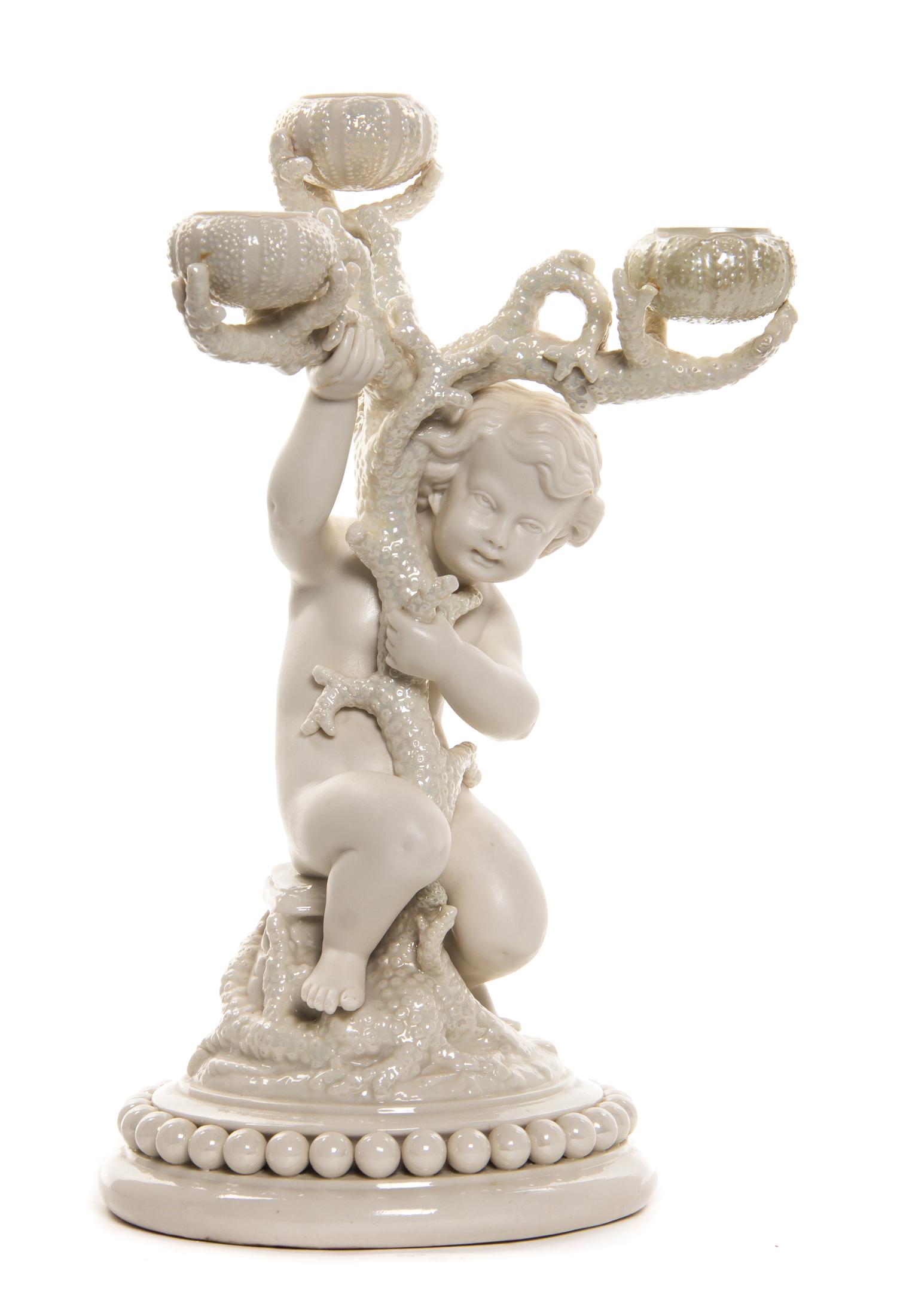A Belleek Boy Three-Light Candelabrum, Height 15 1/4 inches.
