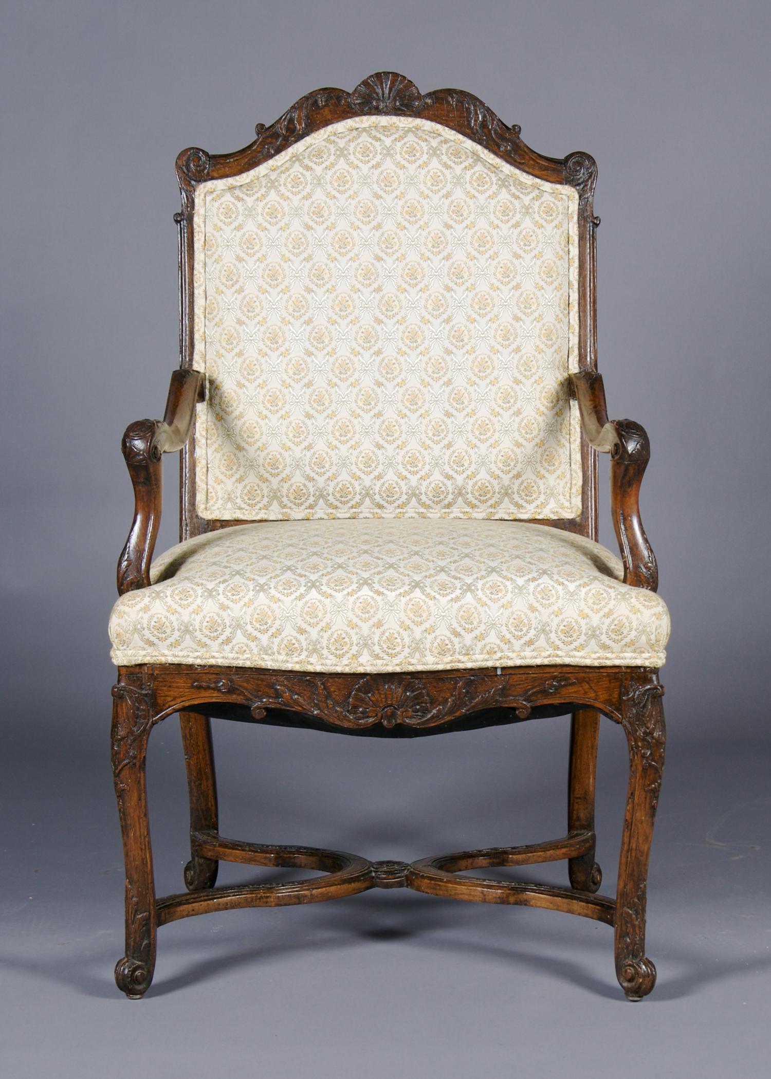 A Louis XV Style Carved Walnut Fauteuil, Height 41 3/4 inches.