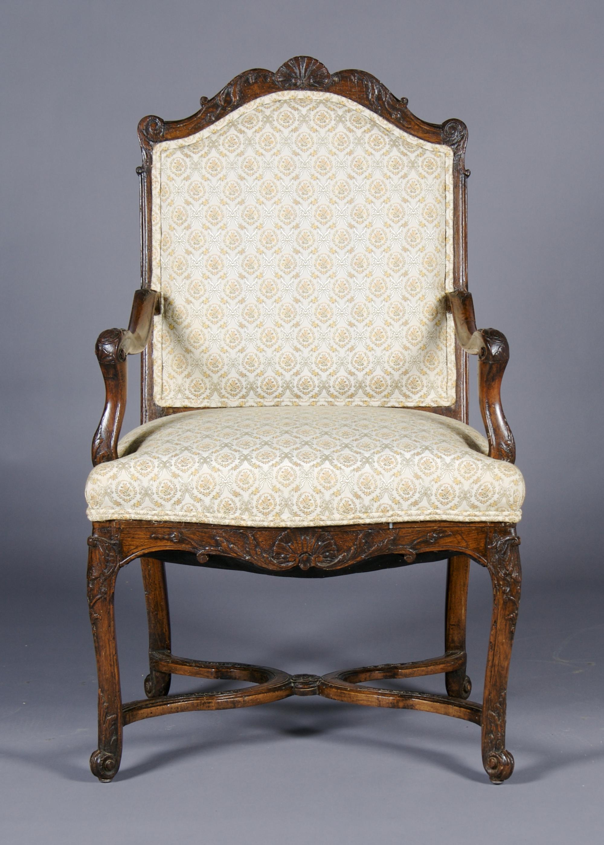 A Louis XV Style Carved Walnut Fauteuil, Height 41 3/4 inches.