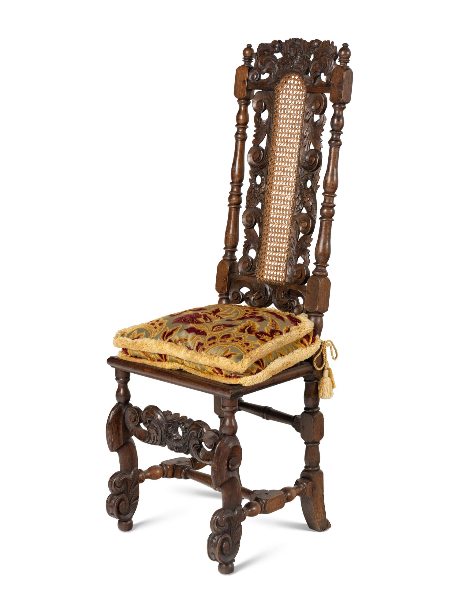 A Set of Four William and Mary Style Carved Oak Dining Chairs