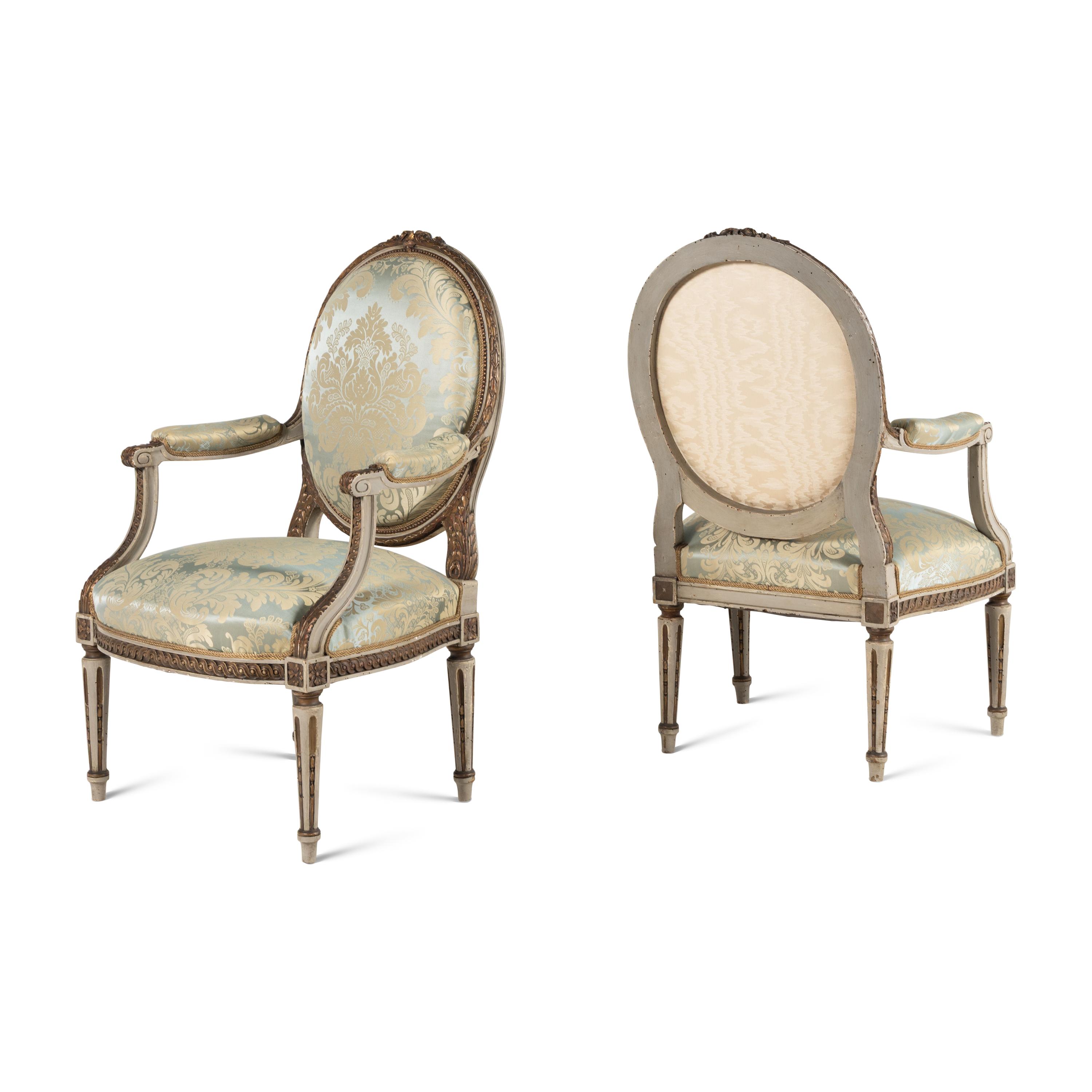 A Set Three of Louis XVI Style Grey-Painted and Parcel Gilt Fauteuils