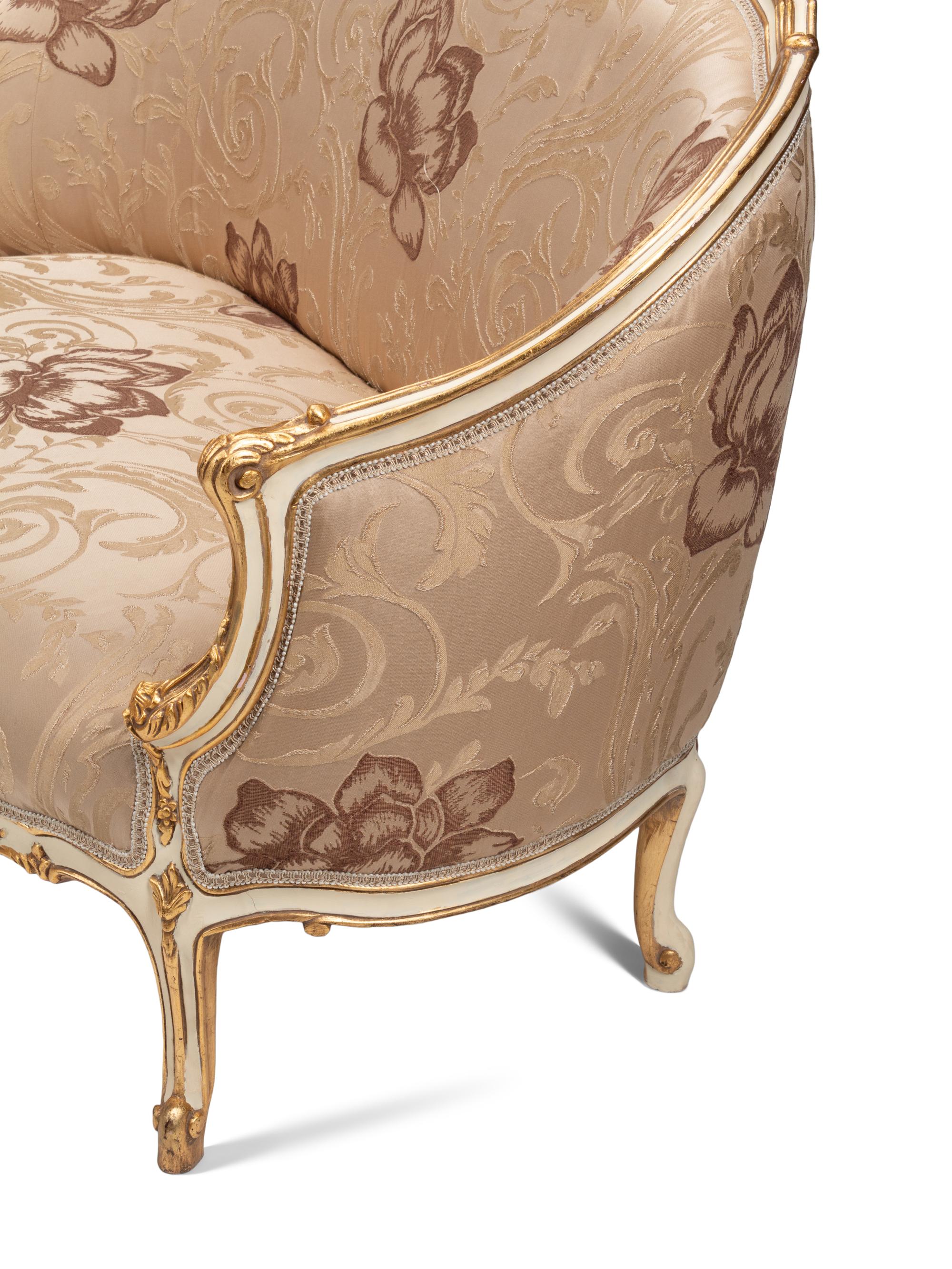 A Pair of Louis XV Style Cream-Painted and Parcel Gilt Settees