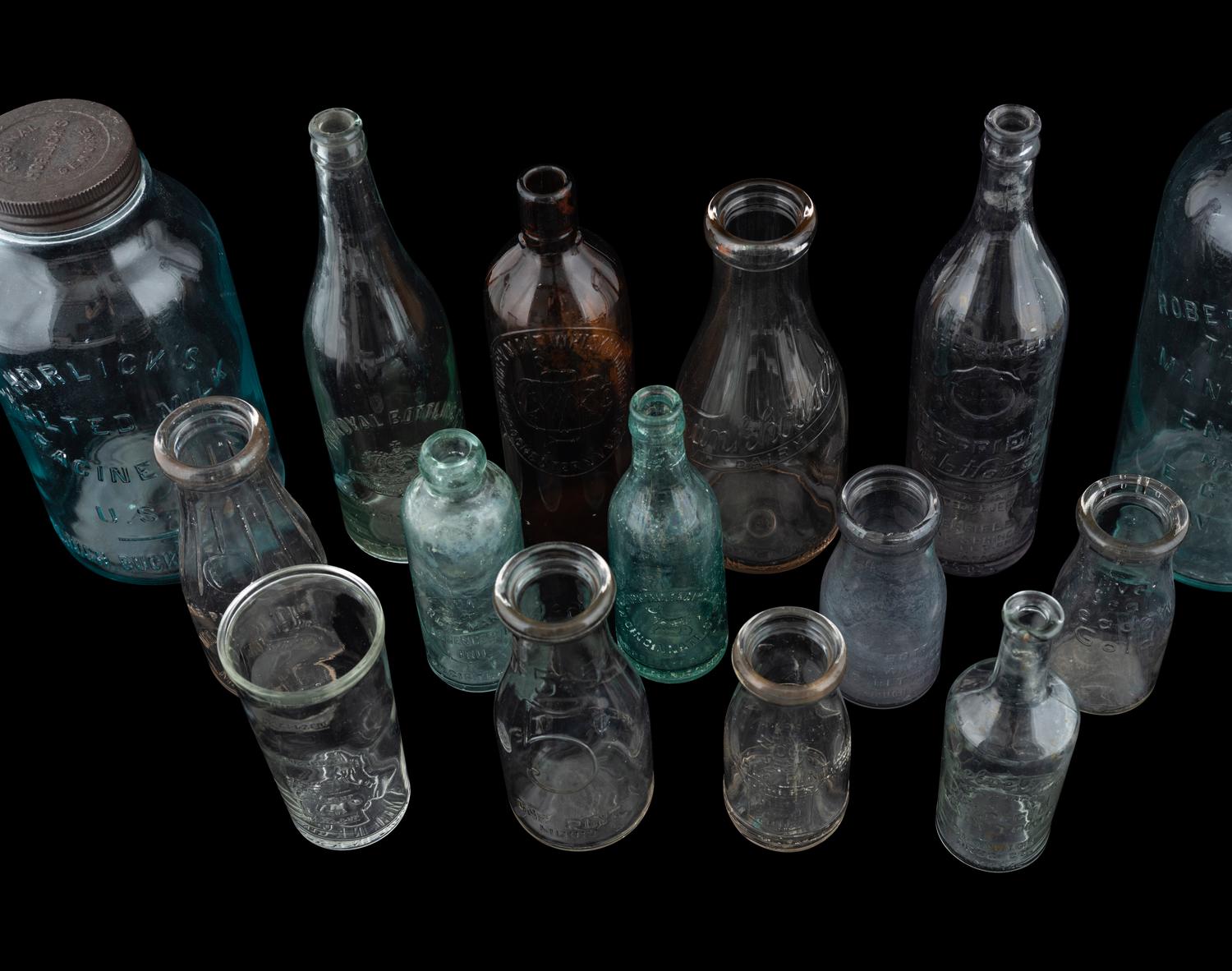 Sixteen Glass Advertising Bottles