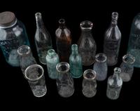 Sixteen Glass Advertising Bottles