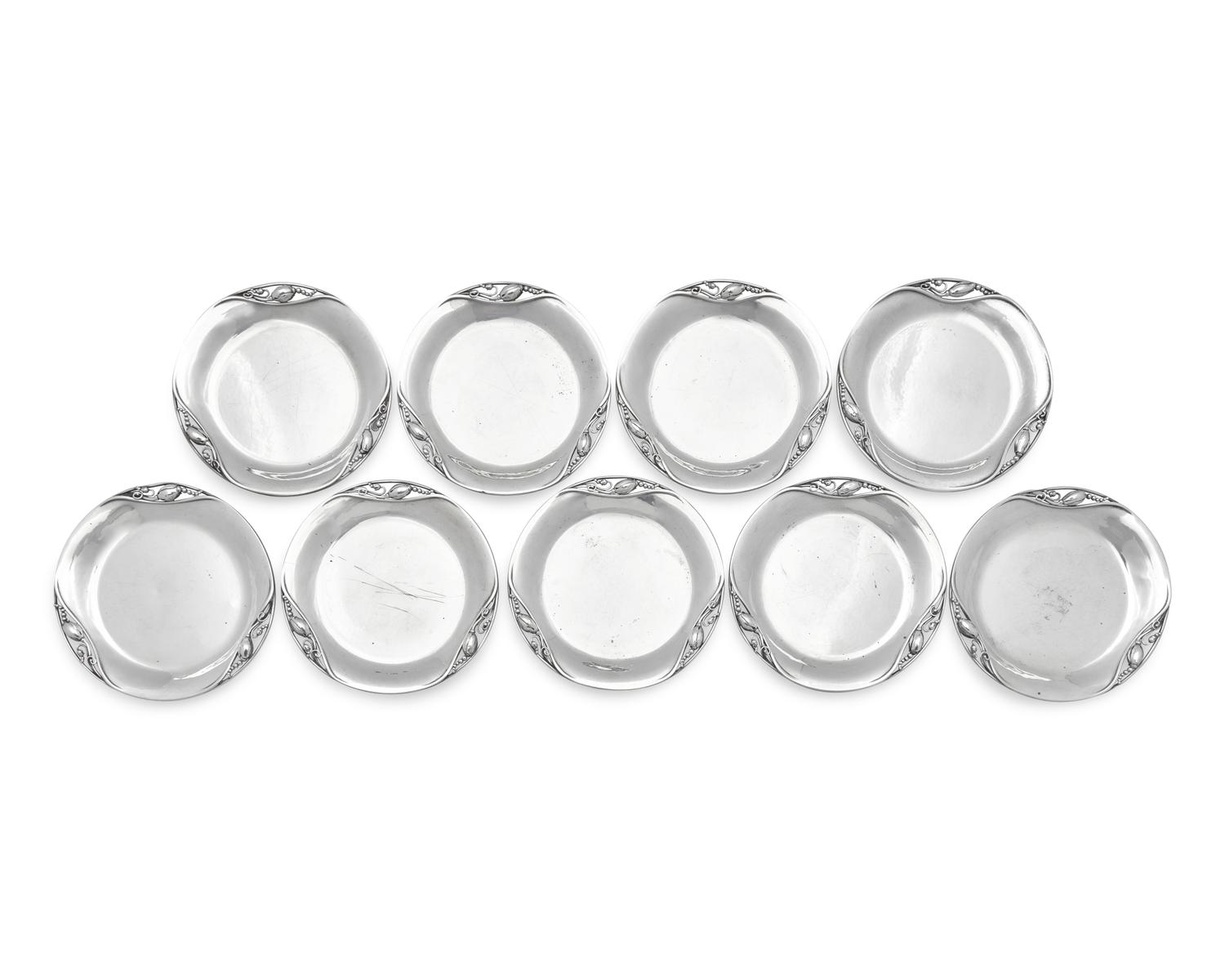 A Set of Nine Georg Jensen Silver Blossom Pattern Bread Plates