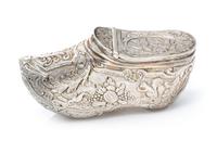 A German Silver Vinaigrette, Maker's Mark Obscured, in the form of a shoe, the exterior chased with floral, foliate and fauna decoratio