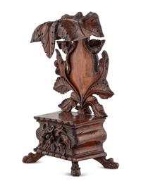 A Black Forest Carved Walnut Stand