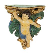 A Pair of Tin-Glazed Earthenware Wall Brackets, and Two Giltwood Wall Brackets
