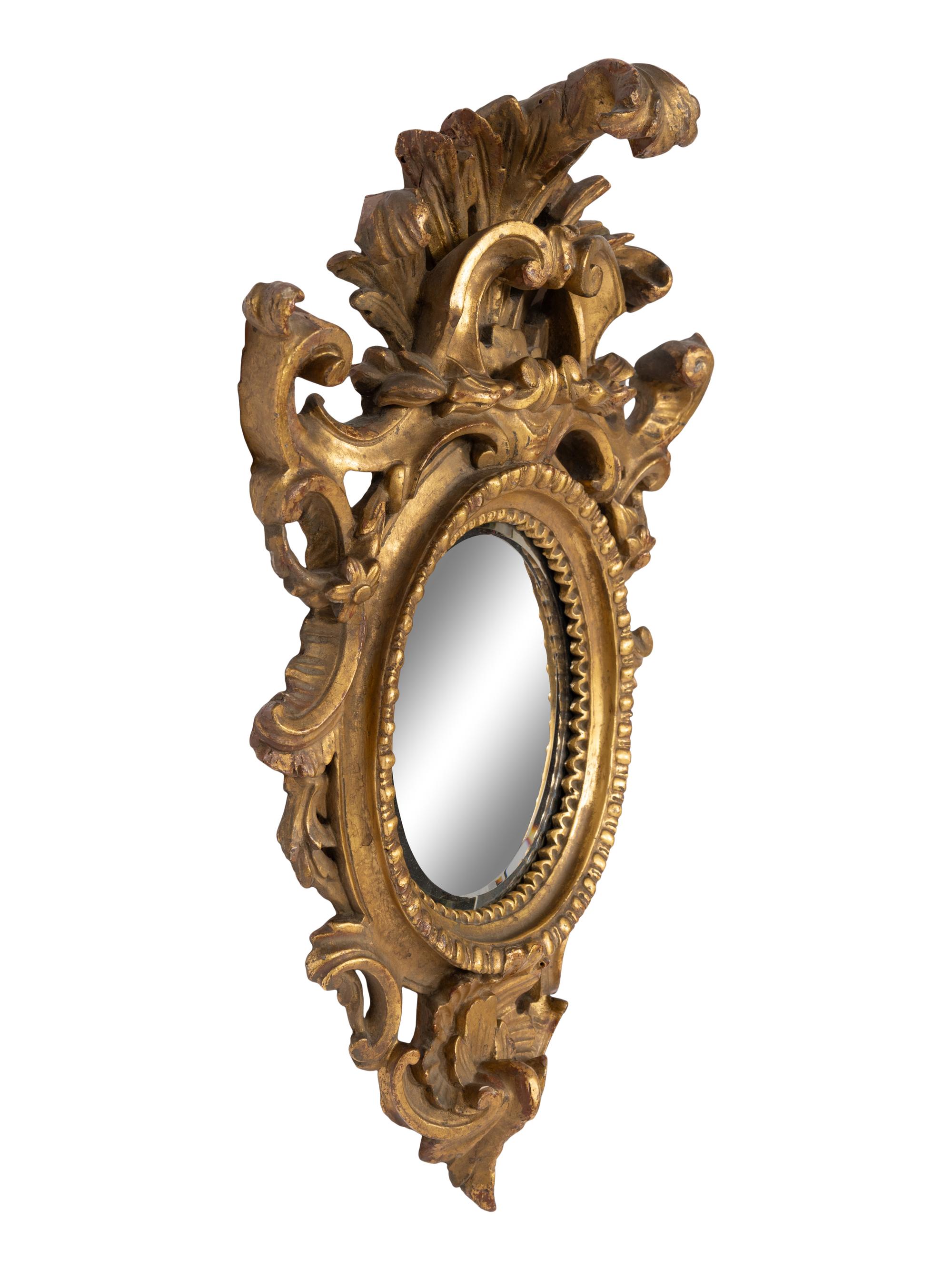 A Pair of Italian Baroque Oval Giltwood Mirrors