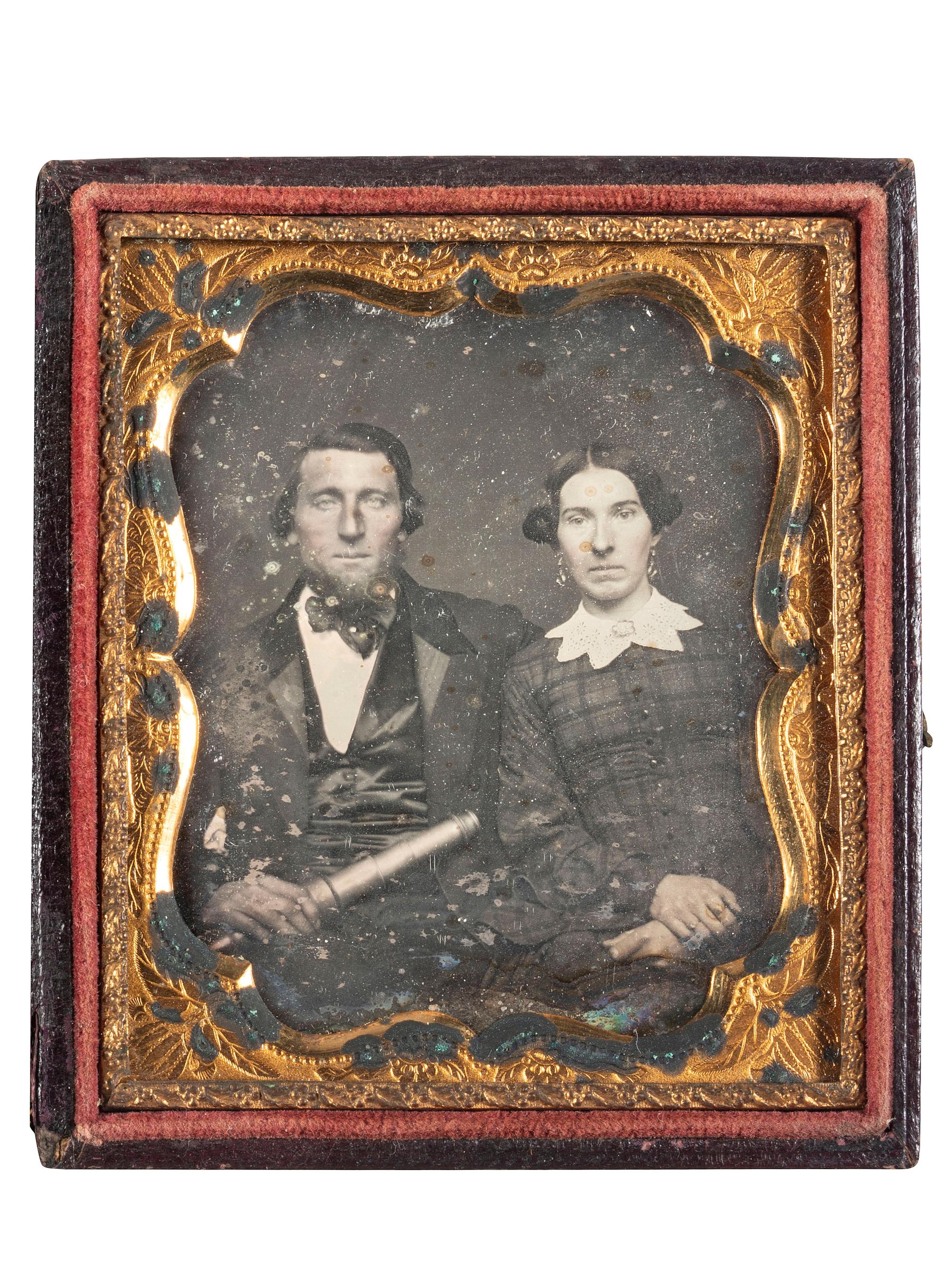 [EARLY PHOTOGRAPHY]. Sixth plate daguerreotype of a man holding a telescope, seated next to his wife.