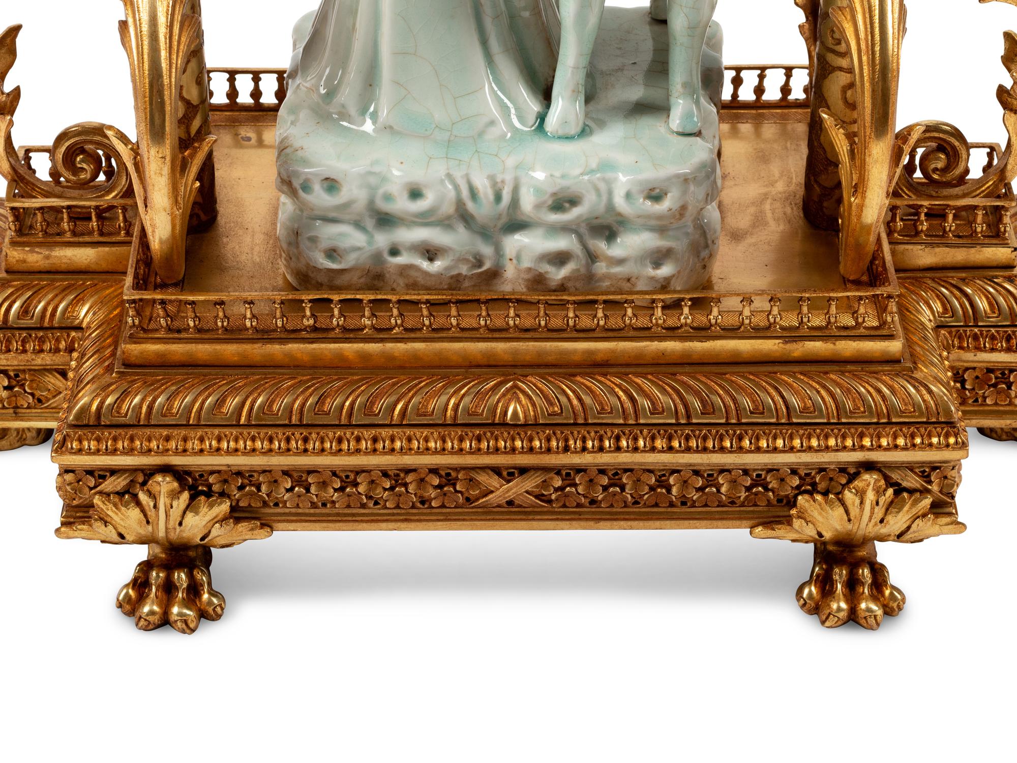 A Continental Gilt Bronze and Celadon Porcelain Figural Chinoiserie Clock