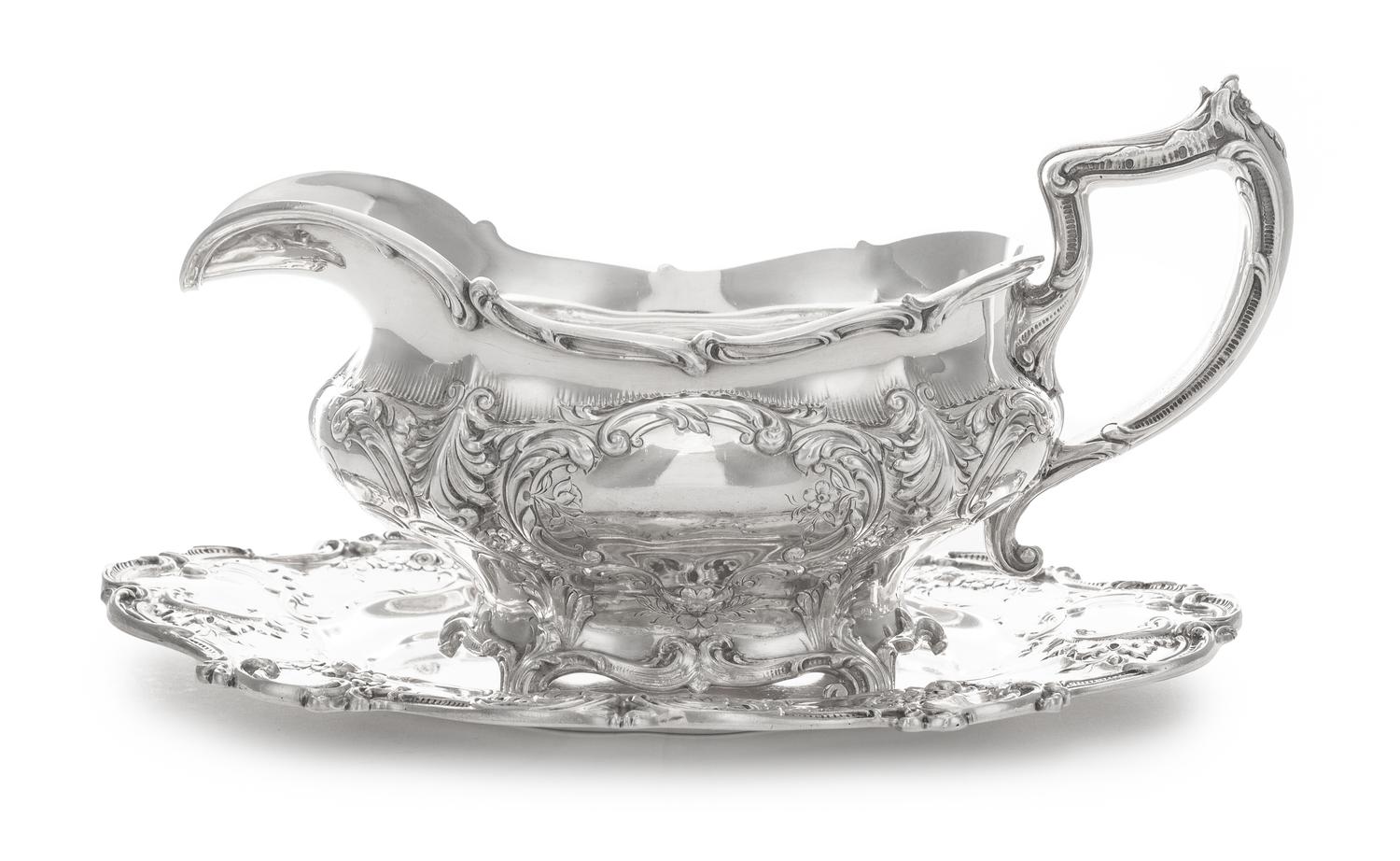 An American Silver Sauce Boat and Stand, Gorham Mfg. Co., Providence, RI, 1907, the bulbous body chased with vacant cartouches raised o