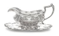 An American Silver Sauce Boat and Stand, Gorham Mfg. Co., Providence, RI, 1907, the bulbous body chased with vacant cartouches raised o