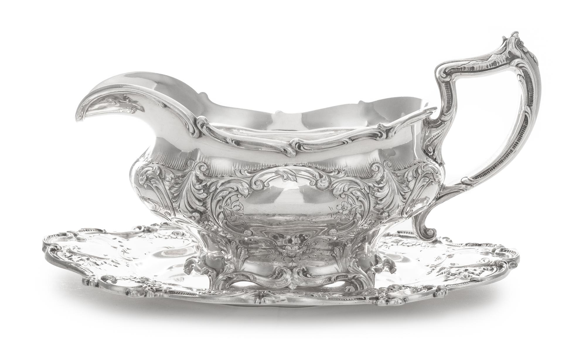 An American Silver Sauce Boat and Stand, Gorham Mfg. Co., Providence, RI, 1907, the bulbous body chased with vacant cartouches raised o