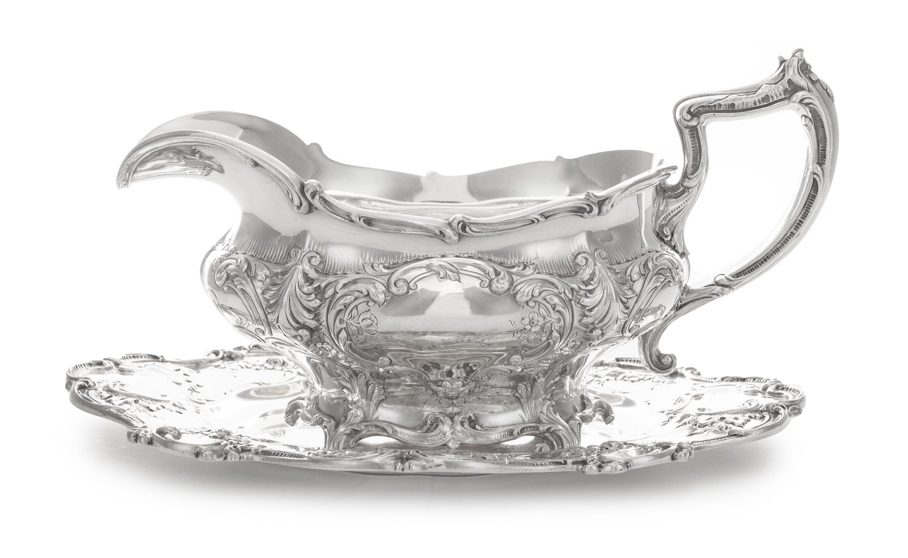An American Silver Sauce Boat and Stand, Gorham Mfg. Co., Providence, RI, 1907, the bulbous body chased with vacant cartouches raised o