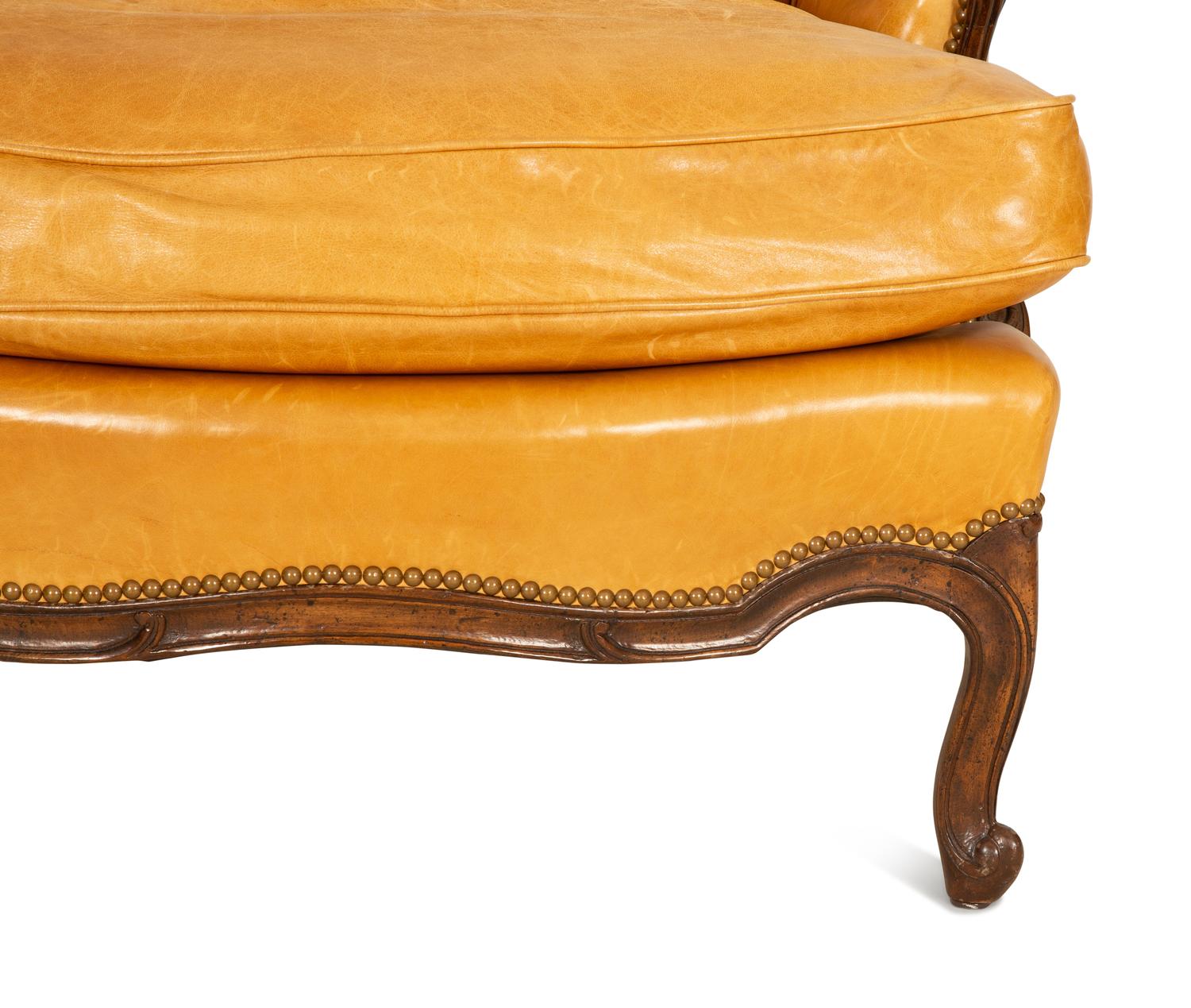 A Louis XVI Style Carved Mahogany Leather Upholstered Bergeré — 20th Century