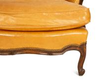 A Louis XVI Style Carved Mahogany Leather Upholstered Bergeré — 20th Century