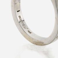 An emerald, diamond, and white gold ring