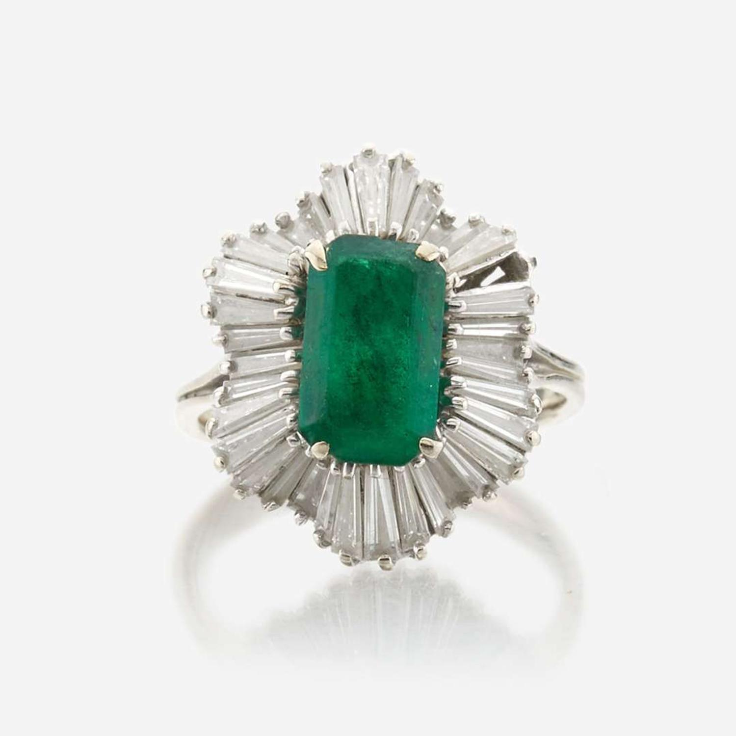 An emerald, diamond, and white gold ring