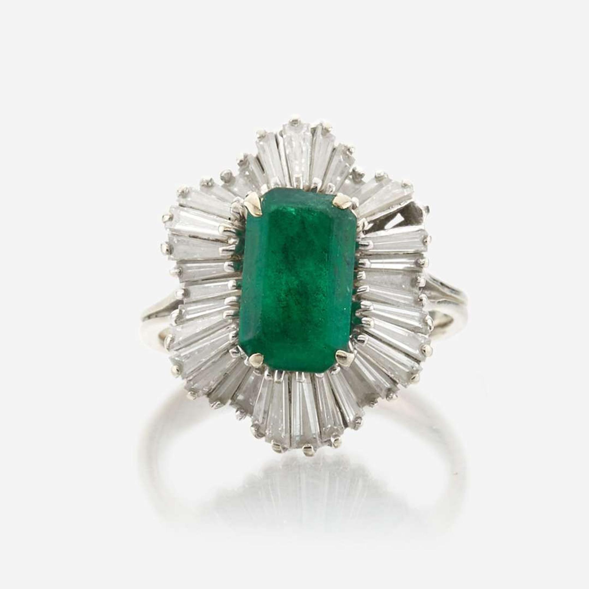 An emerald, diamond, and white gold ring