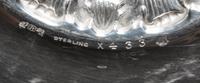 An American Silver Bowl, Reed & Barton, Taunton, MA., 1937, circular, the border chased with dense flowers and foliage, center with a l