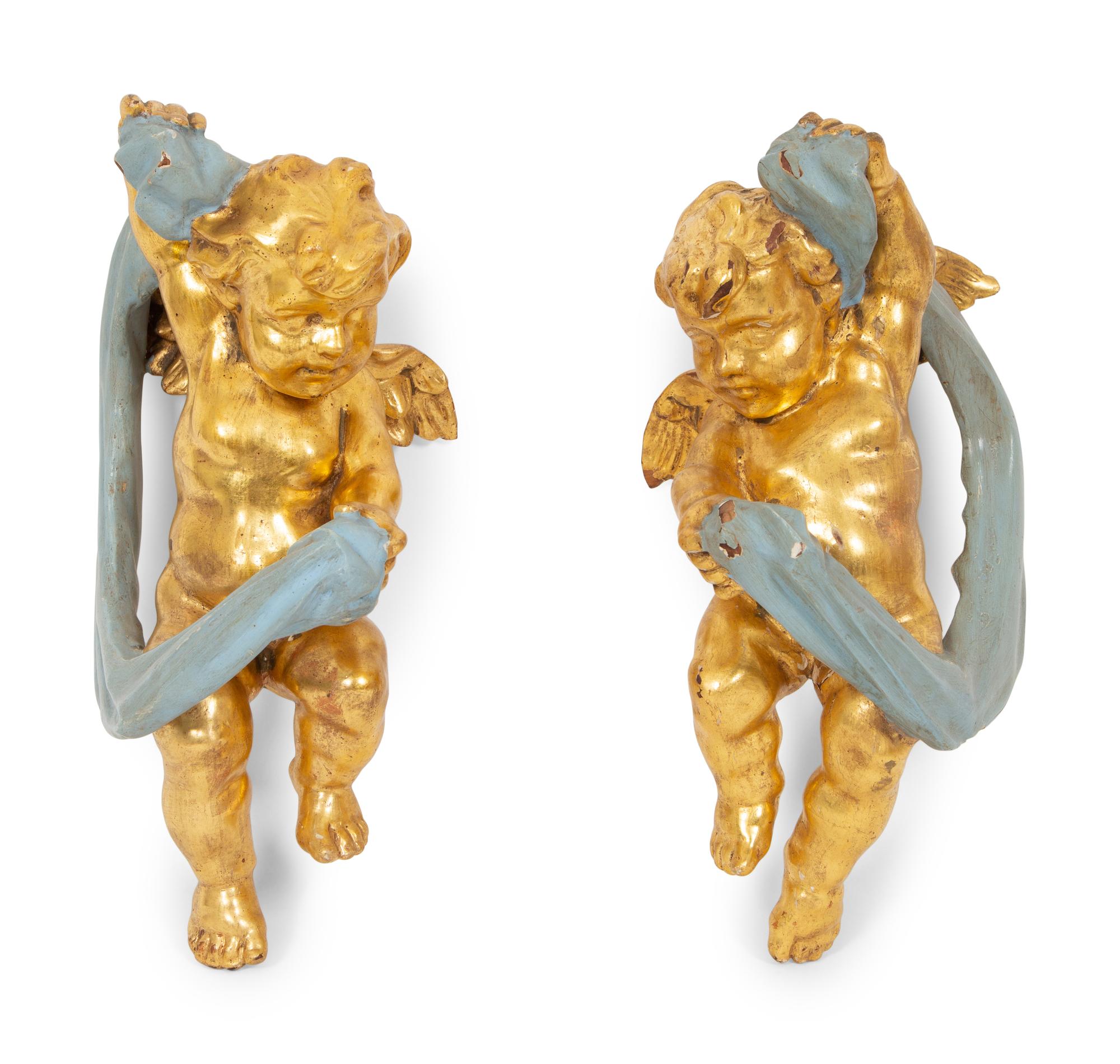 A Pair of Italian Giltwood and Painted Putto-Form Wall Sconces